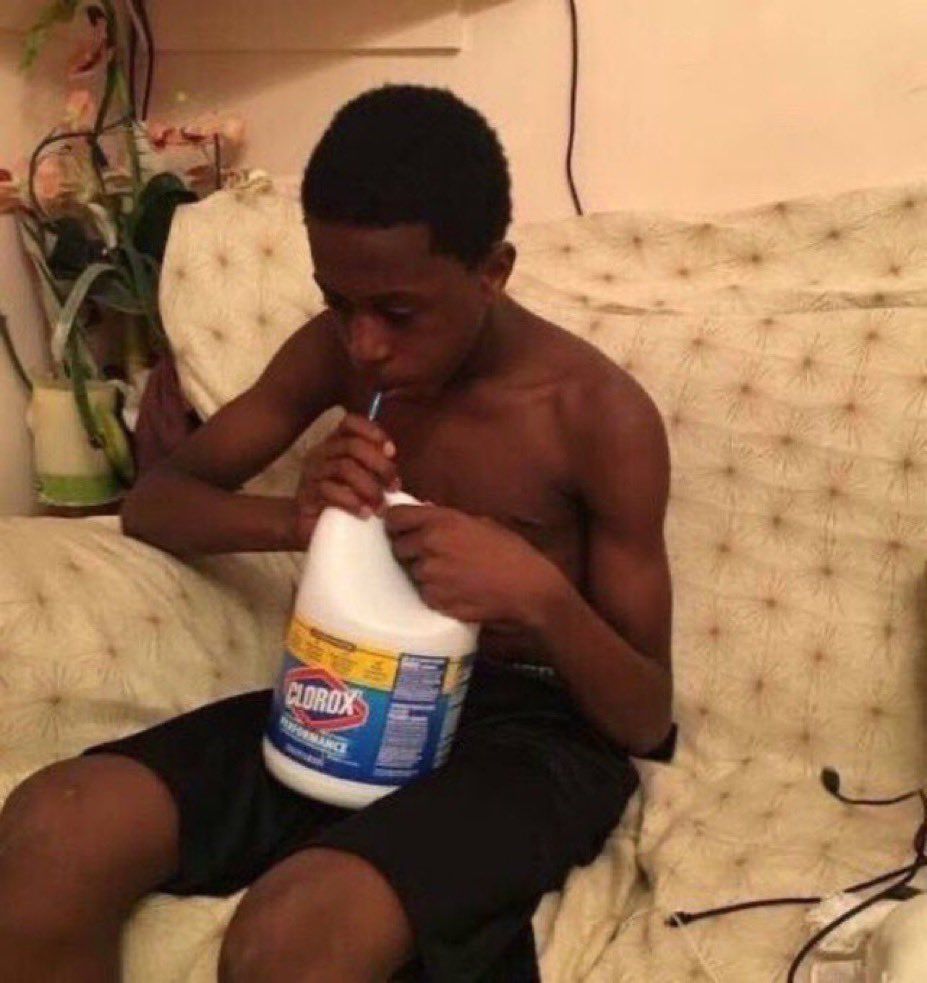 Boy sipping on a bottle of Clorox