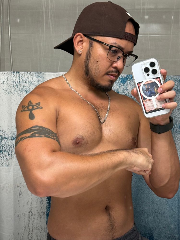 Shirtless mirror selfie with left forearm flexed