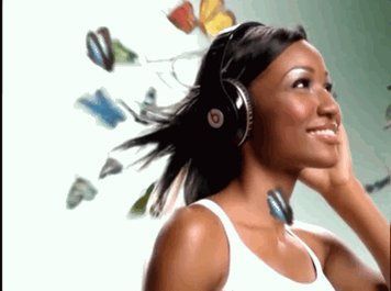 girl w headphones smiling w butterflies flying behind her