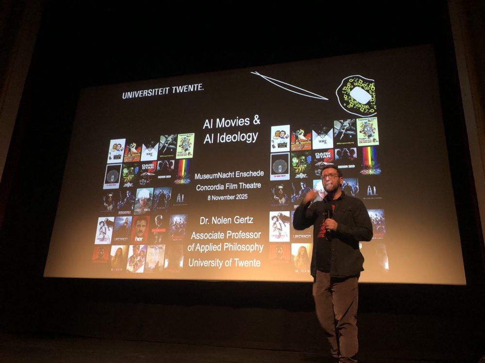 Me standing in front of my slides on the big screen at the Concordia Film Theatre in Enschede 