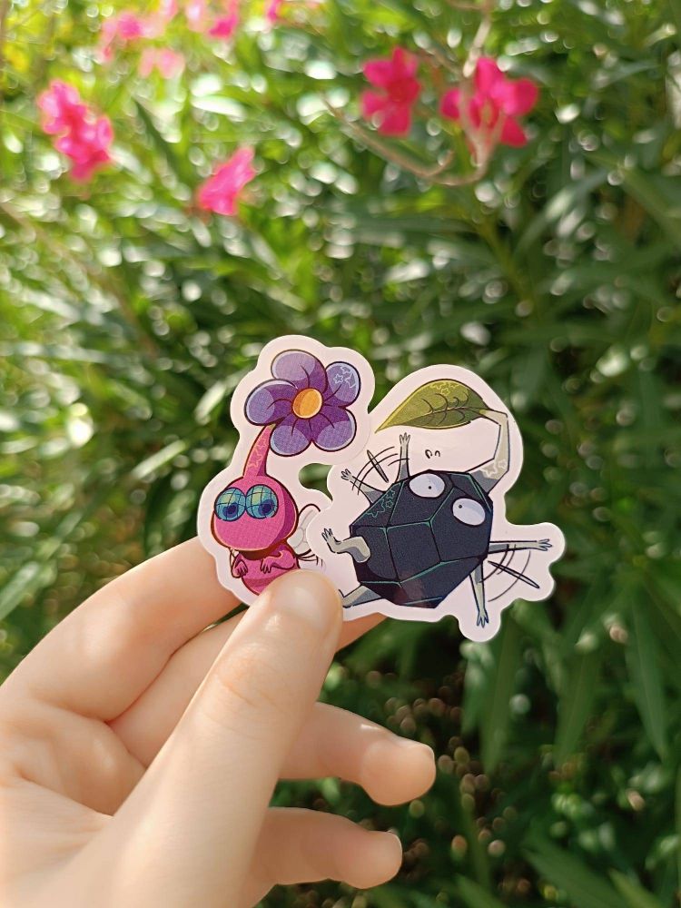 A photo of 2 pikmin stickers (winged pikmin, rock pikmin) designed by me. 
