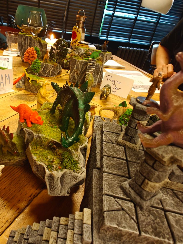 Dino toys on terrain pieces.