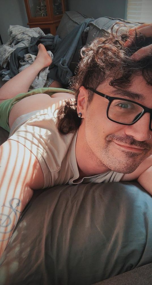 gay on couch with butt out surrounded by blankets and bullshit and idgaf I’m not taking it again