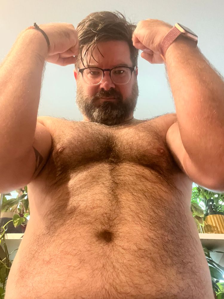 A closeup of a hairy man’s torso