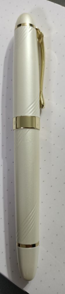 A Pearl white fountain pen with Spiral grooves and gold hardware 