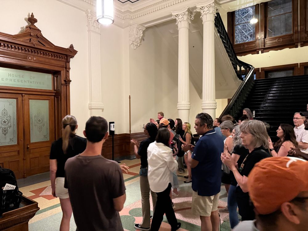 Folks clapping in front of the chamber door