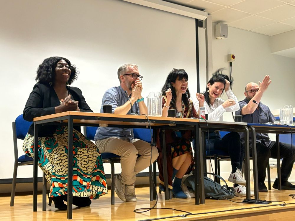 Picture of the roundtable with the participants looking particularly cheerful
