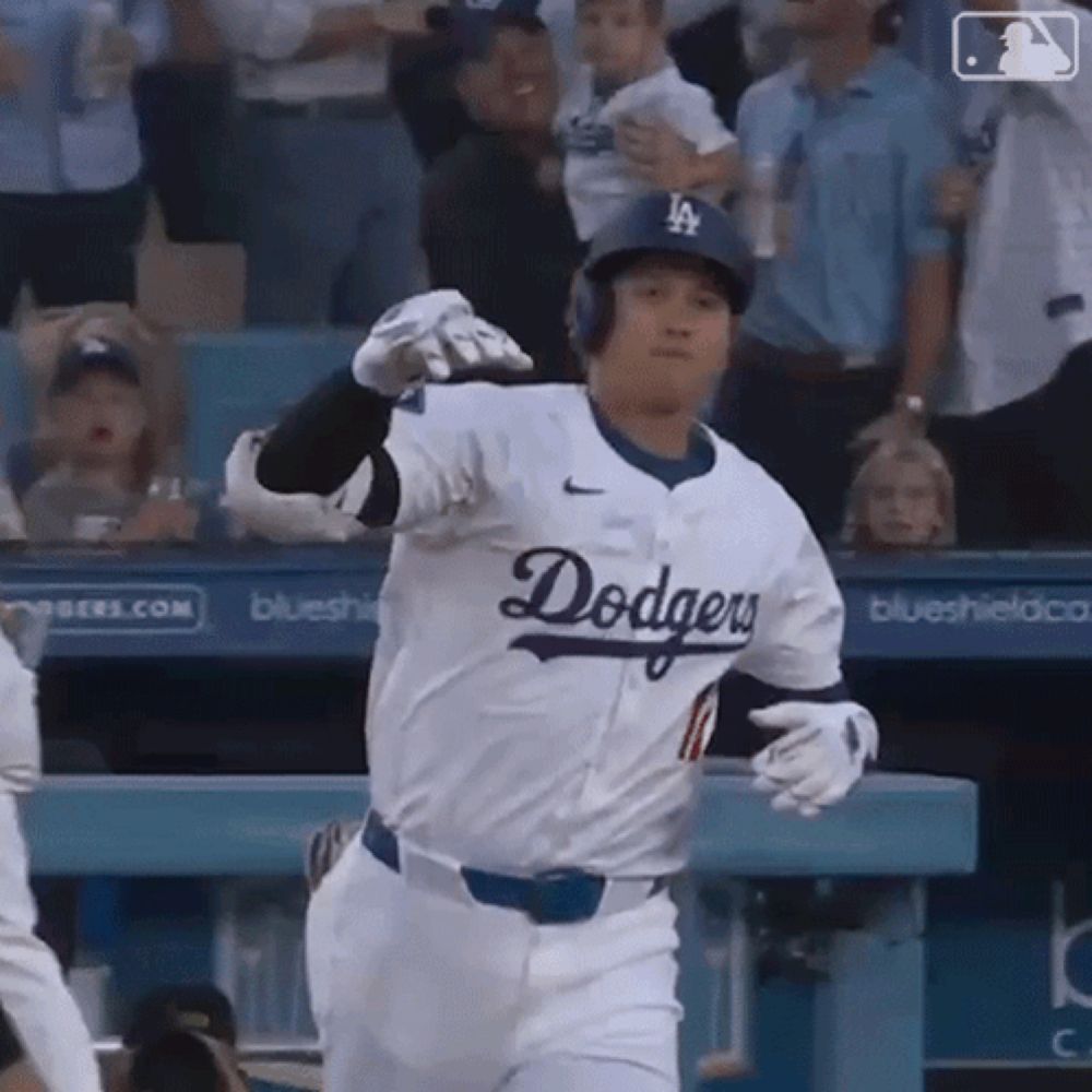 a baseball player wearing a dodgers jersey is running towards the dugout