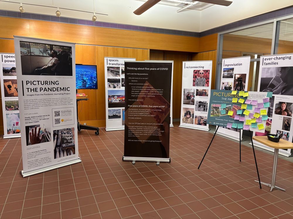 Image shows exhibit banners for the Pandemic Journaling project exhibition, Picturing the Pandemic, in the entrance to the University of Connecticut's Babbidge Library. Exhibition website is at https://picturingthepandemic.org/.