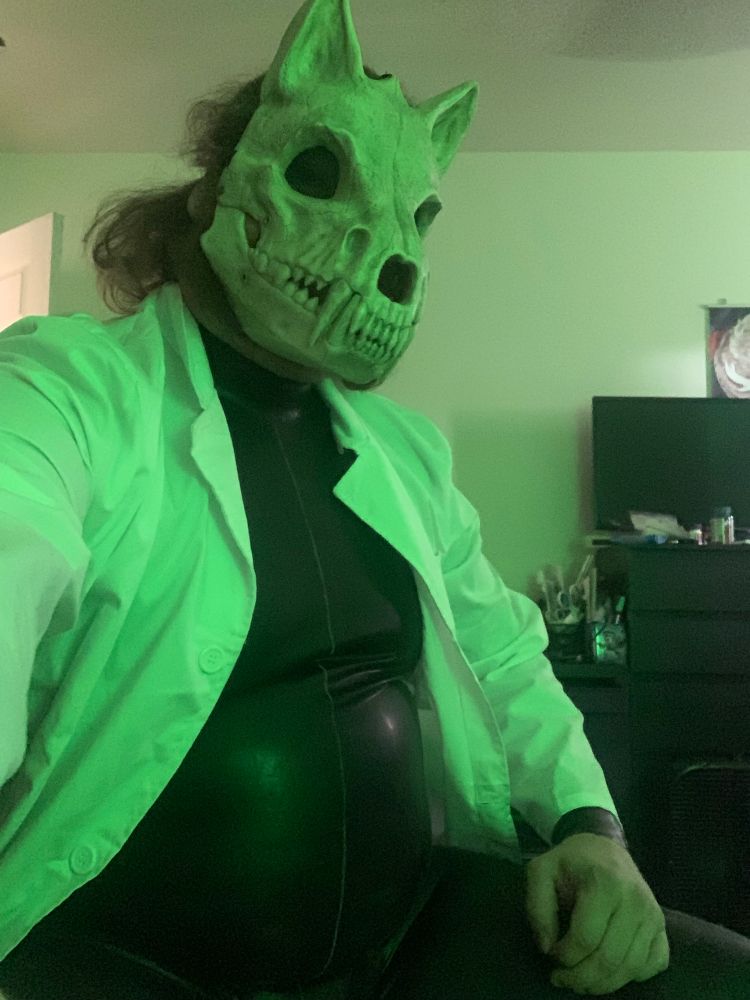 wolf skull mask, latex suit, labcoat