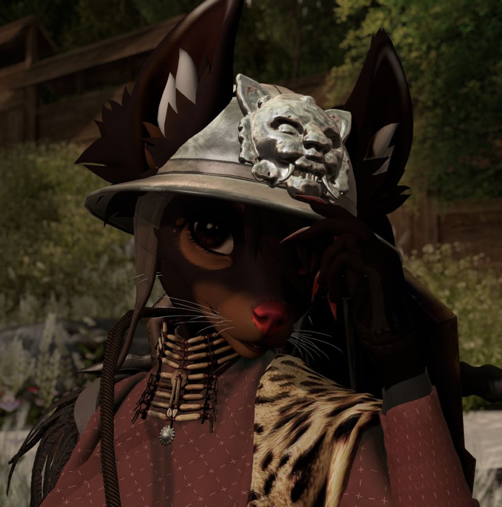 An avatar of an anthro brown-and-tan longhaired chihuahua. She's peeking at the viewer from underneath her helmet with an inscrutable expression. 