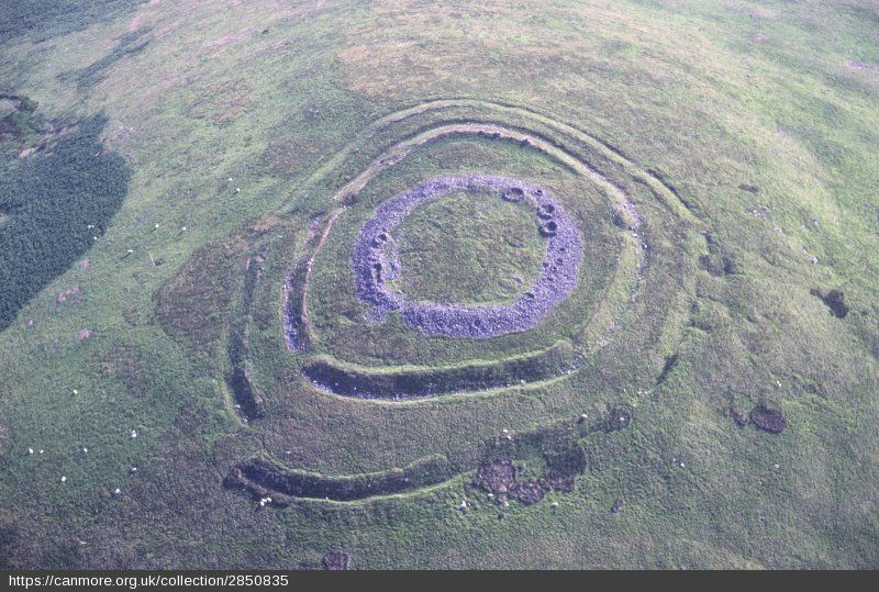 Aerial photo showing the three ramparts of Arbory Hill Fort in an open upland moorland.