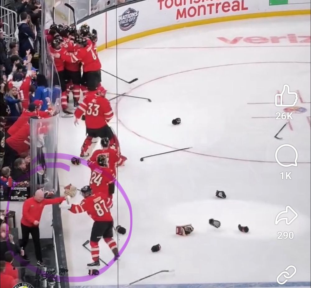 Sidney Crosby pauses to fist-bump a trainer before going to celebrate the gold medal win with his teammates.