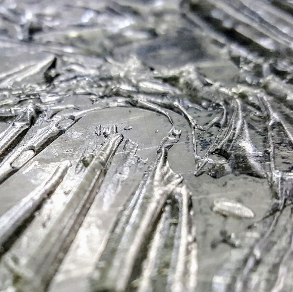 Ice imprint on stainless steel appears like a topographical map 