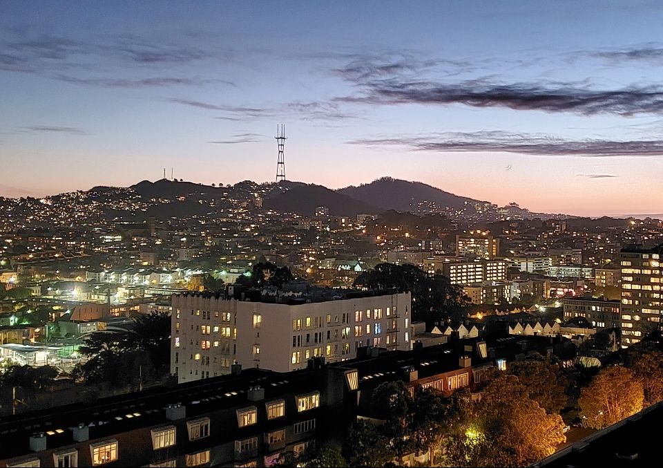 View of San Francisco from the 11th floor of Carillon Tower apartments facing SW. Cityscape at dusk with Sutro Tower in distance.