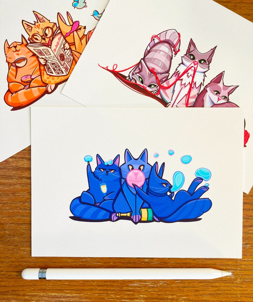 Three mini prints of cats in various situations. In the first print, three blue cats are bursting bubbles. In the second print, three cats are having fun with a ball of yarn. In the third print, three cats are starting their morning.