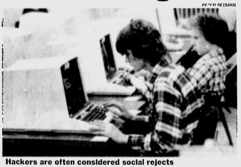 Black and white photo of people in checked shirts at computers, from 1981.