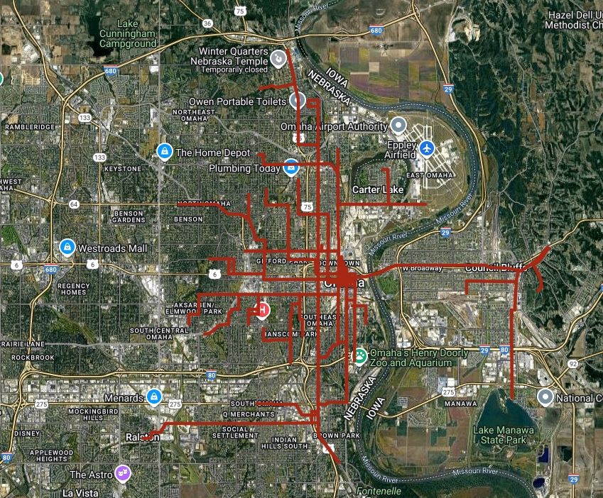 satellite map composite image of the greater omaha metro area in eastern nebraska, with a surprising number of user-added lines showing where omaha streetcars used to run all over the city