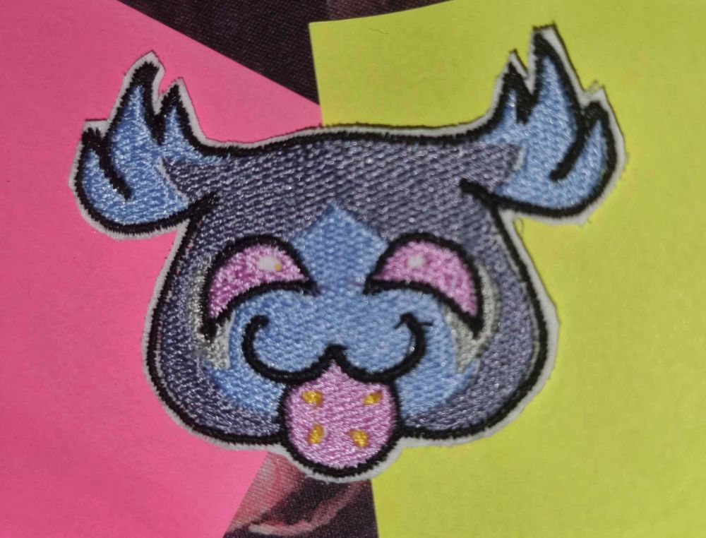 a purple creater with pink eyes eating a pink fruit with golden seeds