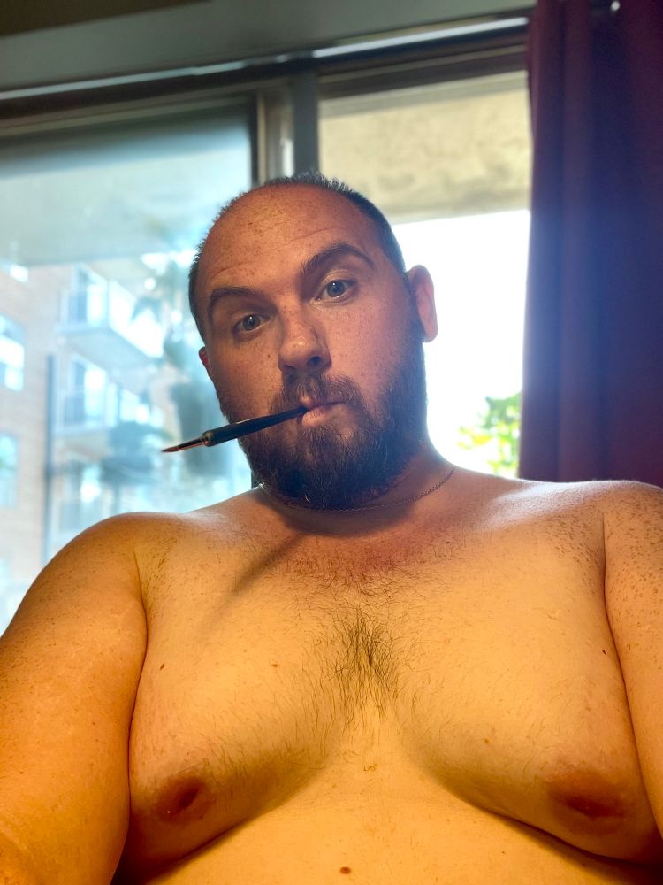 Me shirtless at the easel