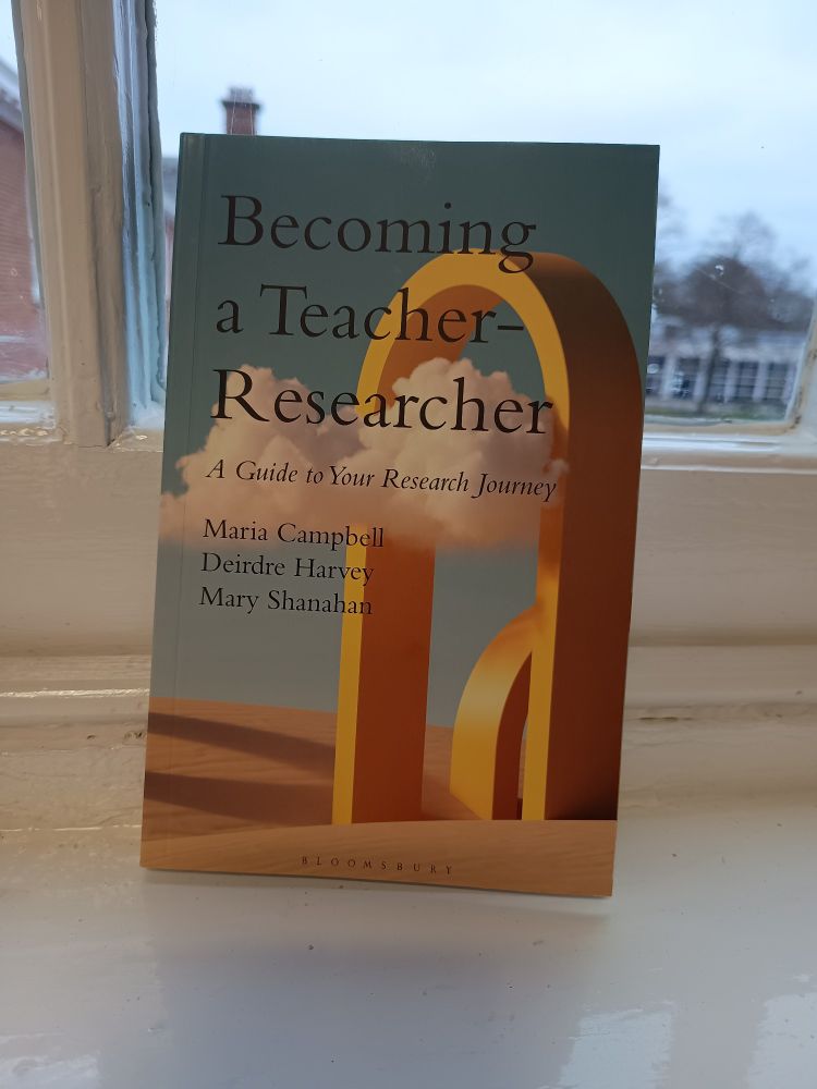 A book with the title 'Becoming a Teacher-Reaearcher: a guide to your research journey' and the names of the editors 