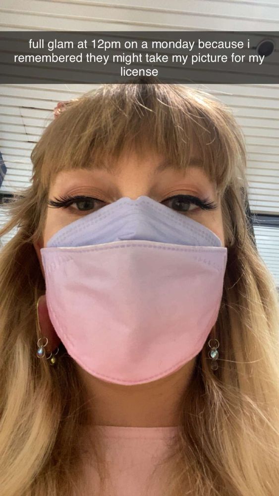 picture of me in a mask looking at rhe camera false lashes on captioned "full glam at 12pm on a monday because i remembered they might take my picture for my license"