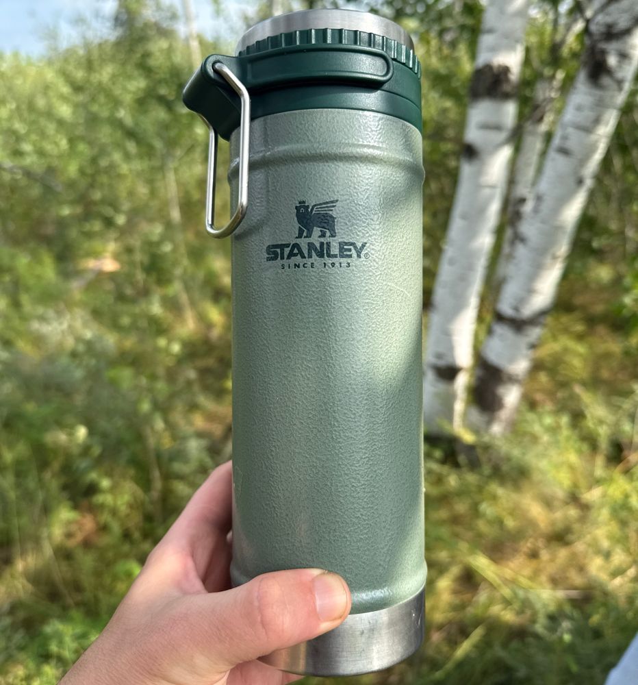 Photograph of a green Stanley brand travel coffee French press
