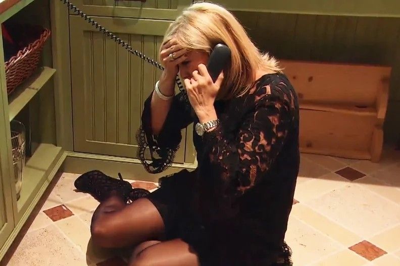 Vicki Gunvalson sitting on the floor crying on the phone 
