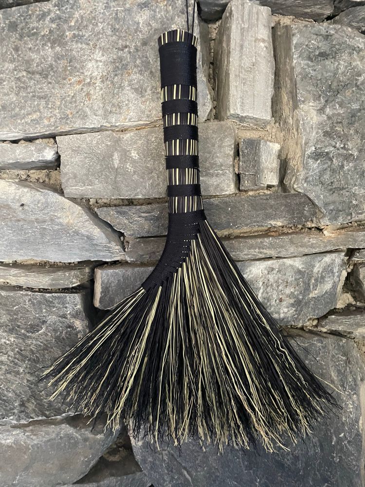 Black and natural colored hand sewn hawk tail whisk broom. 