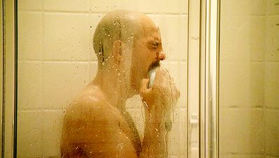 Tobias Funke, never-nude, shown mid-chest up, crying in an otherwise unremarkable shower.