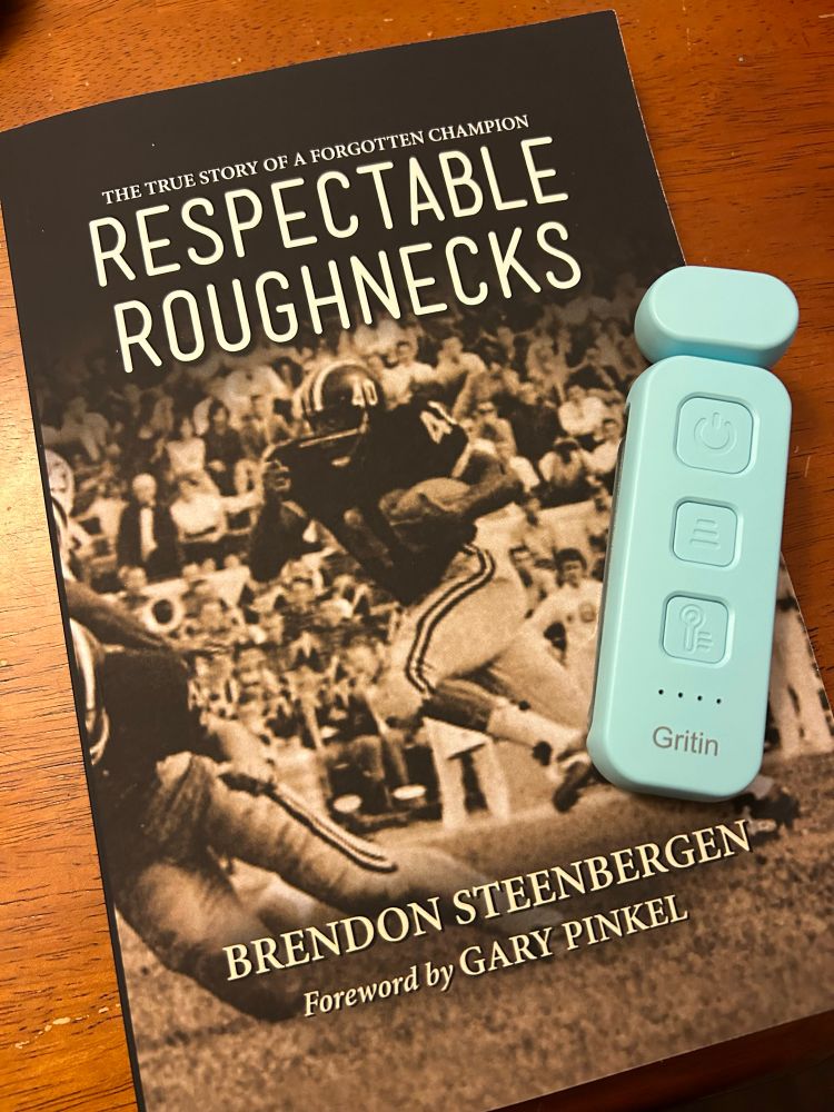 Copy of “Respectable Roughnecks” book and a book light.