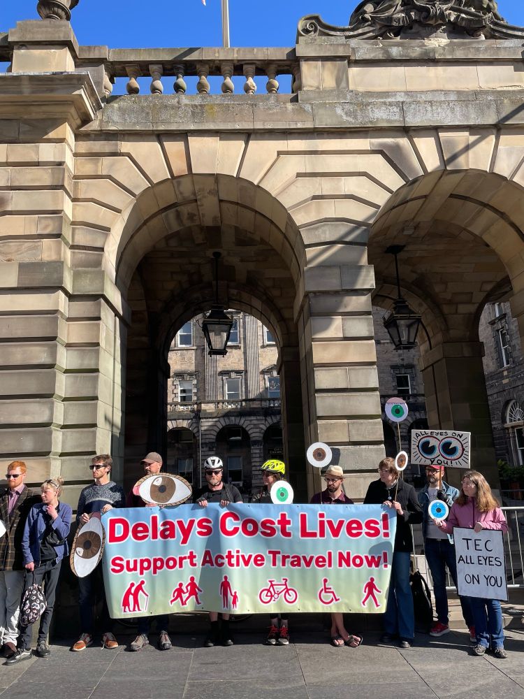 Picture of protest "Delays Cost Lives"