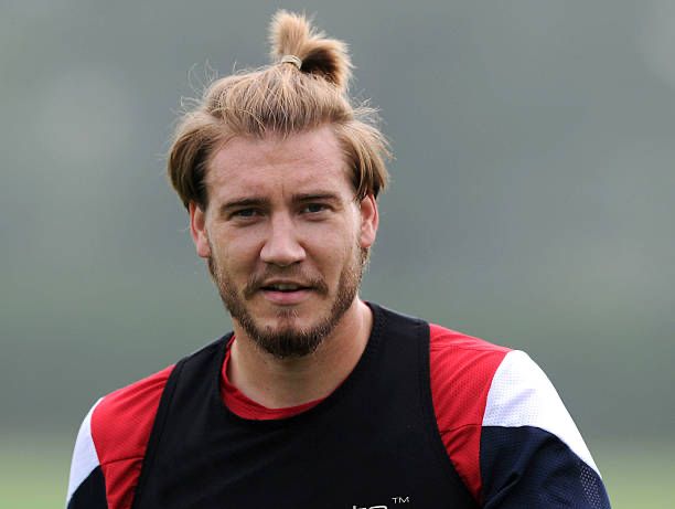 Lord Nicolas Bendtner, wearing Arsenal training gear, with a beard a few weeks old and the most perfect hair you can imagine shaped into a man-bun