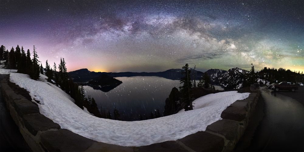 Panorama of Crater Lake National Park under the glitter of the night sky