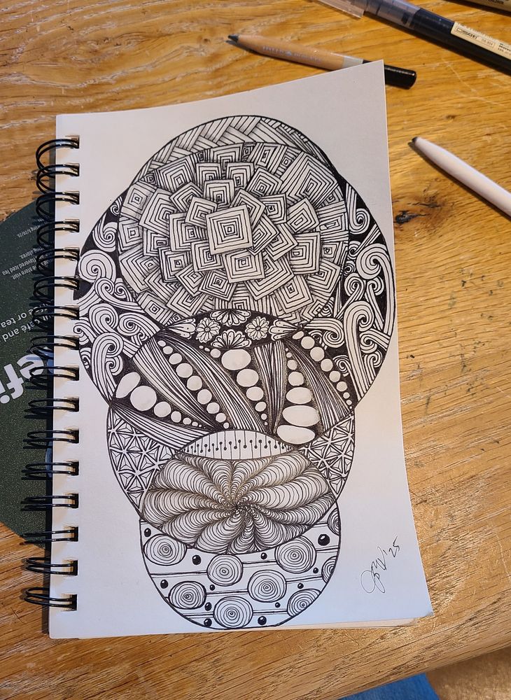black ink on white sketch paper, circles filled with various tangle patterns and shaded with graphite