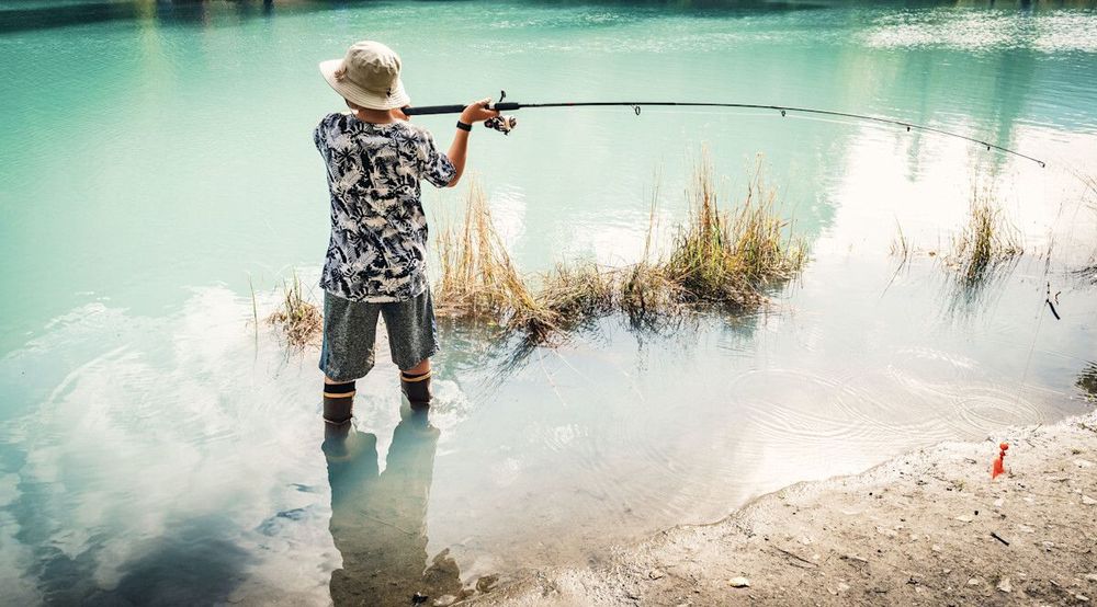 Boy Fishing for Silvers at Eklutna Tail Race in Alaska at a Youth Salmon Derby