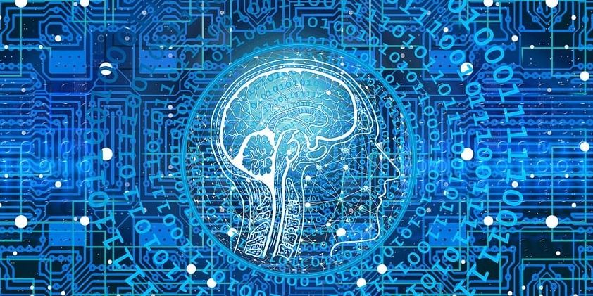 This image shows a profile view of a head with brain with binary code around it.