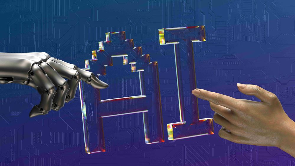 Robot hand and human hand pointing towards AI letters with a blue background.