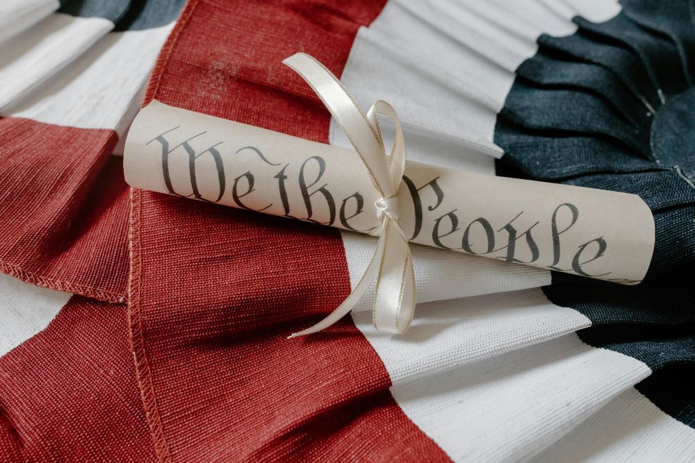 American flag with the constitution on top of it