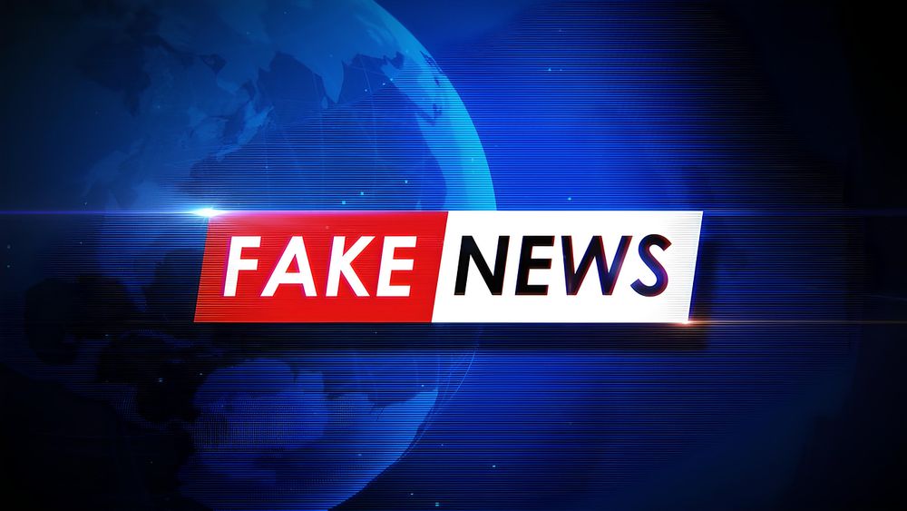 This image shows a blue background with the words fake news.