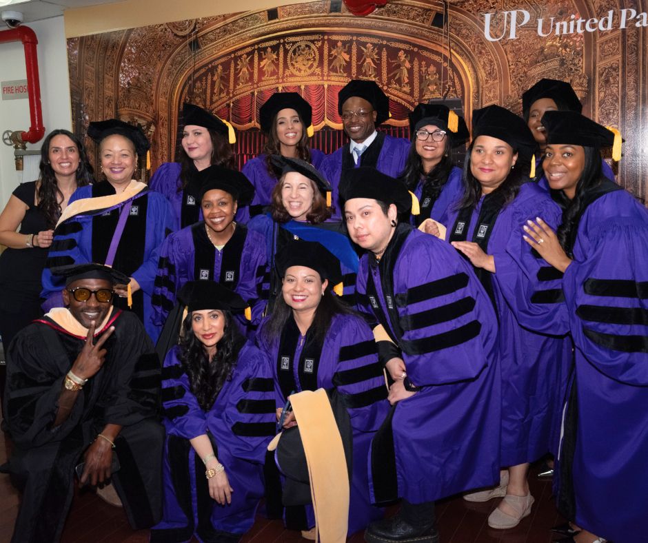 Graduates of NYU Silver's DSW Class of 2025 pose in their caps and gowns with program leadership before the graduation ceremony.