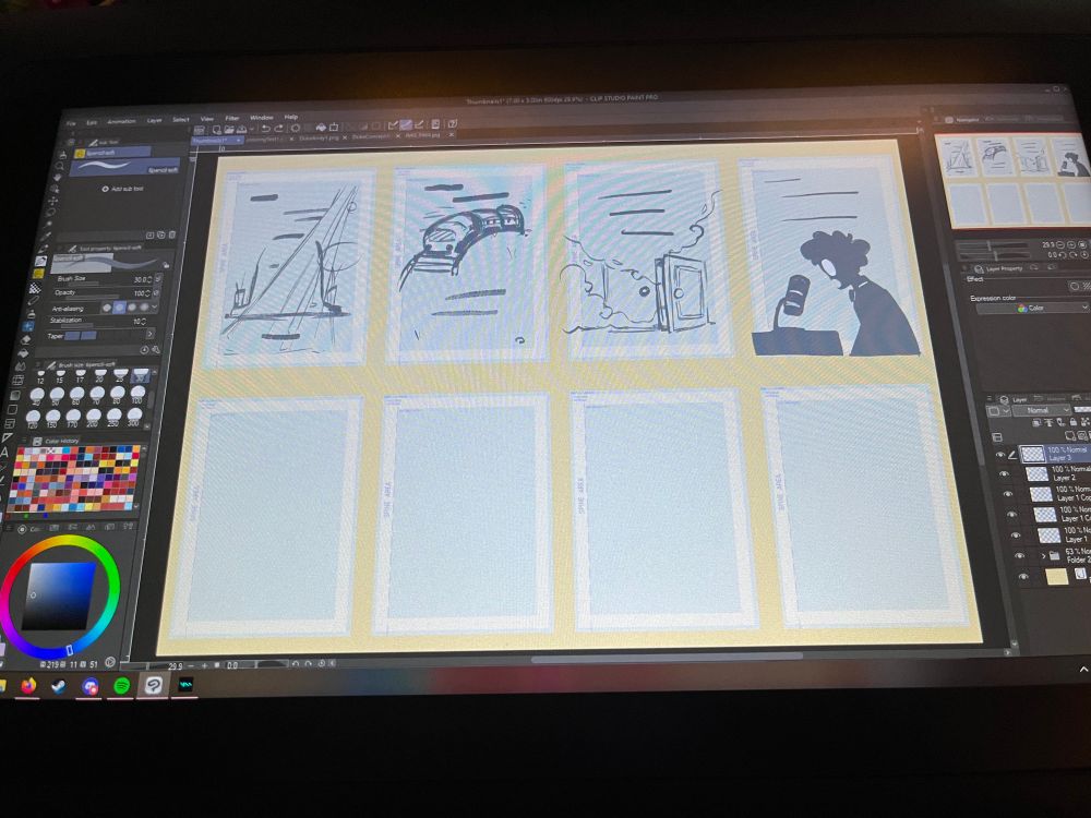 Picture of a drawing tablet with comic page sketches on it