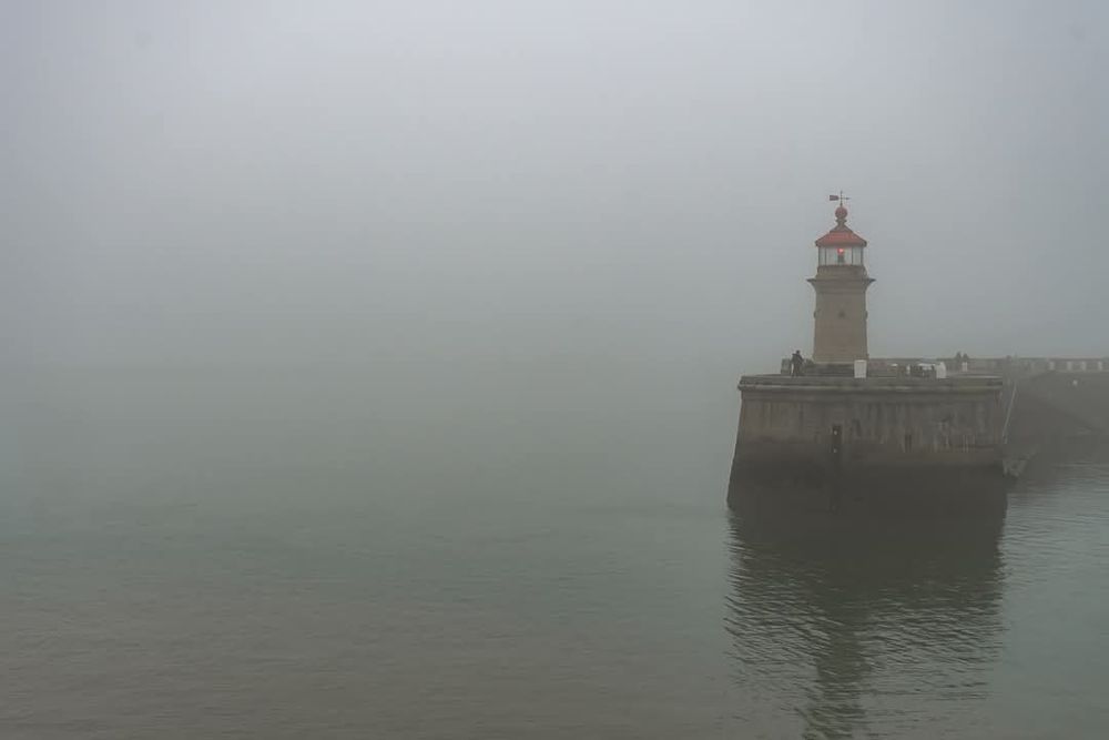 Ramsgate lighthouse at the end of the harbour arm, peeking through the mist