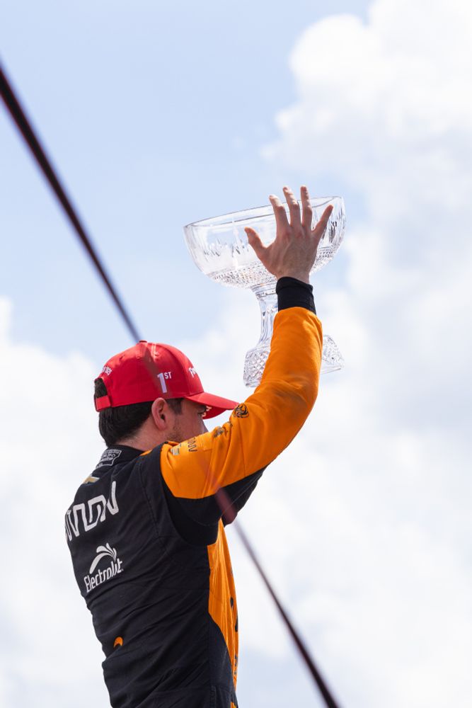 Pato O'Ward raising the trophy for the winner on Sunday in Toronto.
