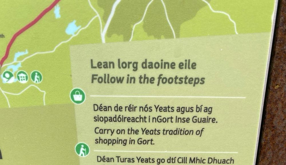 Sign reading “Carry on the Yeats tradition of shopping in Gort.” 