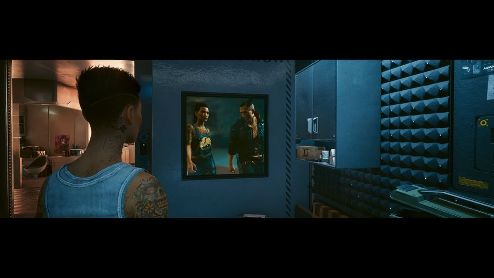 My V staring nostalgically at a picture of her and her late amigo, Jackie Welles