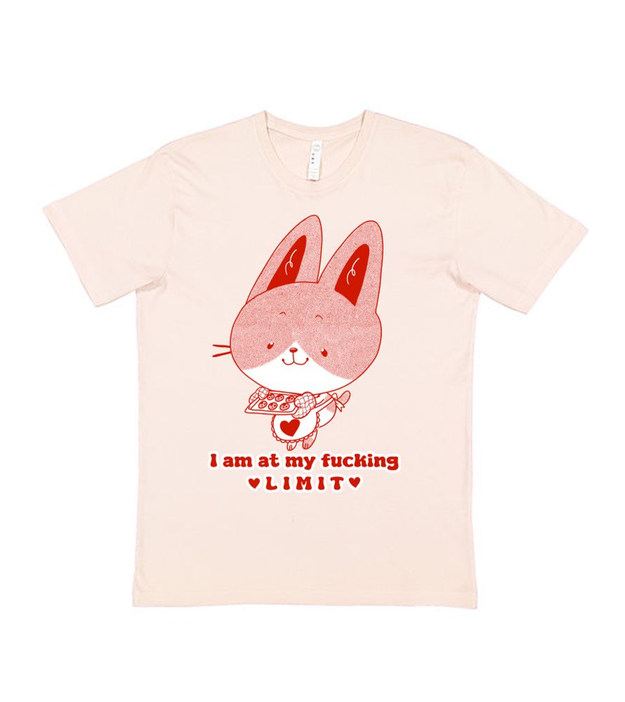 A shirt with a cute cat design holding baked cookies with a heart apron. The text reads "I am at my fucking limit" with hearts