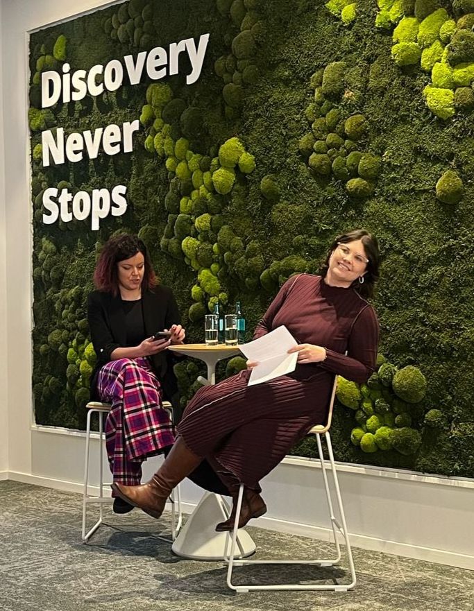 Christene makes a silly face to the audience during the interview