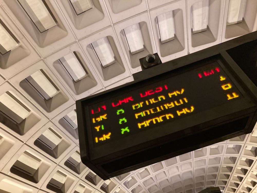 Photo of interior of DC metro, electronic sign says Green Line to Branch Ave arriving in one minute. Photo by C.Drahl