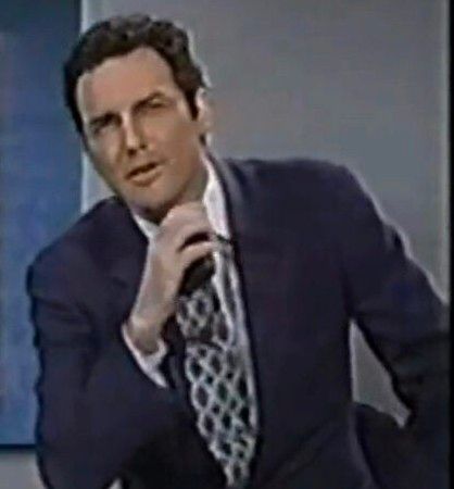 Norm MacDonald talking into a tape recorder